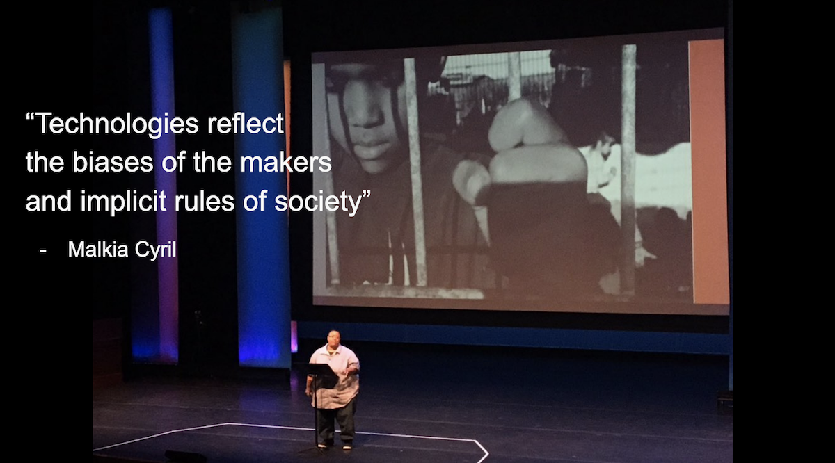A person saying :Technologies reflect the biases of the makers and implicit rules of society" with a photo of an incarcerated Black person in the background