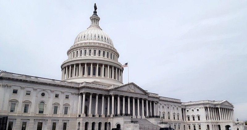 The US Capitol building, with a grey sky in the background.