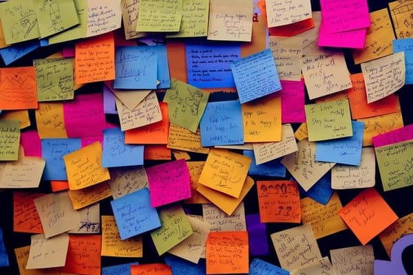 Dozens of colorful post-it notes, with writing ont hem but it's too small to read